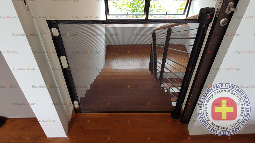 Top of stairs installation of retractable gate at bedroom entrance