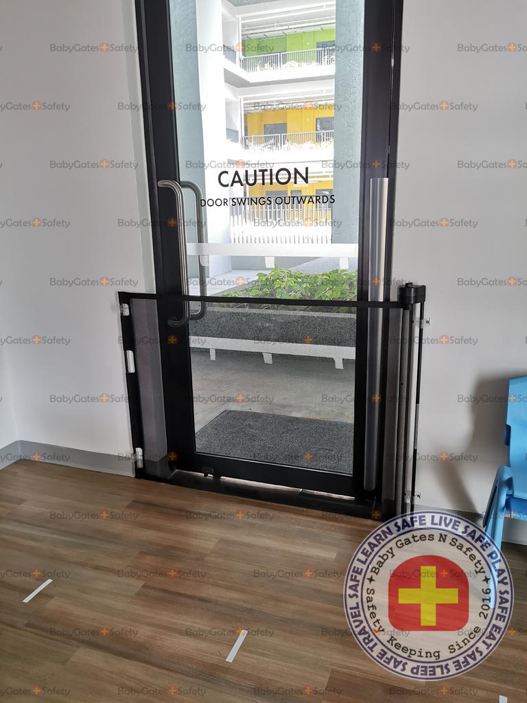 Retractable safety gate on the inside of childcare entrance
