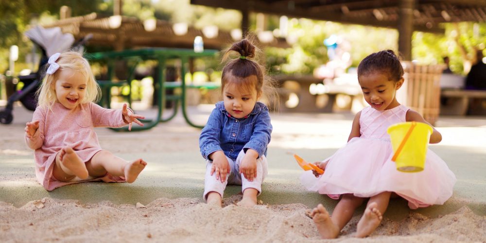 toddler-trio-playing-with-sand